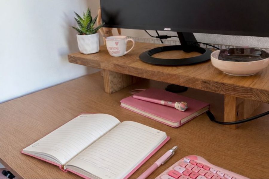 Scrivania con monitor, pianta e quaderno aperto per progettare un sito